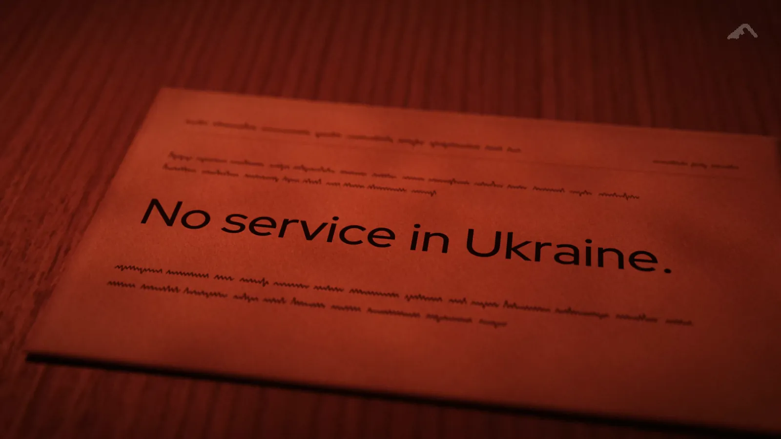 A printed card on a desk, lit red, reading: No service in Ukraine.